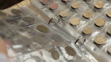 Numismatics concept. Collection of coins from different countries in album