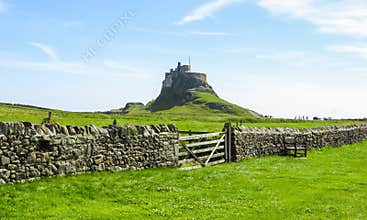Lindisfarne Castle panoramic view, rock fence and wooden gate, Holy Island, Northumberland