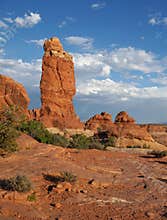 Freestanding red Navajo Sandstone pinnacle in a dry desert environment