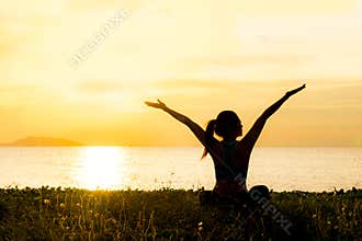 Meditation yoga lifestyle woman silhouette on the Sea sunset, relax vital.