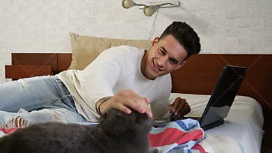 Young Man Working on PC, Petting Pet Cat
