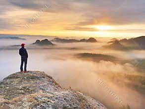 Beautiful moment the miracle of nature. Colorful mist in valley. Man hike. Person silhouette stand