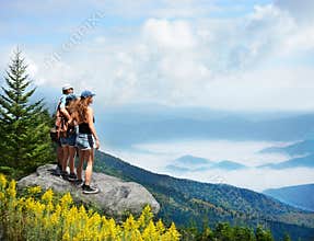 Family enjoying beautiful view of foggy mountains.