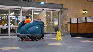 Motion of airport workers cleaning floor during night inside YVR airport