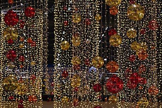 Colorful christmas Decoration. Winter holidays and traditional ornaments on a Christmas tree. Lighting chains - candles for season