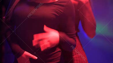 Two blonde women enjoying dance in night club, people relaxing at disco