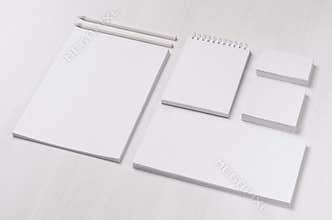 Branding business mock up of white blank stationery set on light soft white wooden background, inclined.