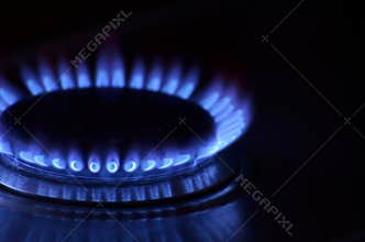 Kitchen stove gas flame close-up. Gas burning in the darkness.