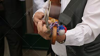 Close-up of male musician playing guitar on the street, music performance