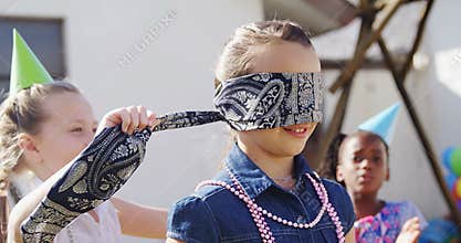Girl tying blindfold on friend 4k