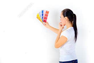 Girl painter chooses the color of paint to repair