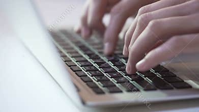 Person typing on laptop keyboard, freelancer sending project to client by email