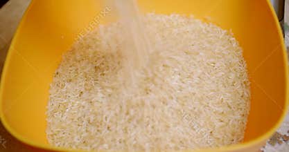 Rice is poured into a bowl