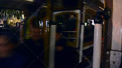 Two world-famous cable cars carrying tourists cross each other in Union Square, San Francisco