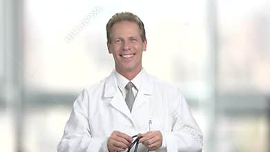 Happy mature doctor with stethoscope.