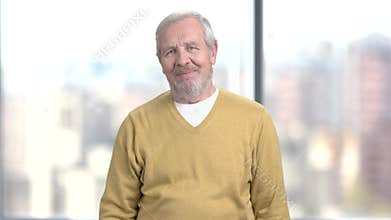 Older man showing ok sign.