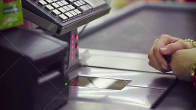 Woman working on cash register in the store