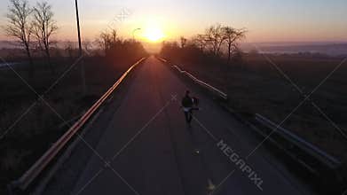 A pair of dancers perform a synchronized ballet jump at dawn