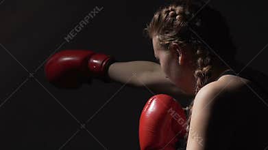 Female boxer doing air punching training, Muay Thai combat sport, martial arts