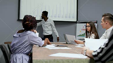 African american coach gives corporate presentation for businesspeople in office, dark skinned businessman presents new