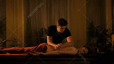 Young woman enjoying massage at spa salon