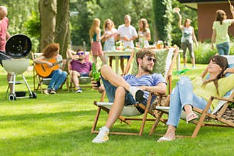 Young friends having barbecue picnic