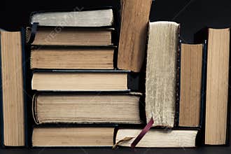Old books pile on black table