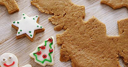 Gingerbread dough with star shapes on wooden table 4k