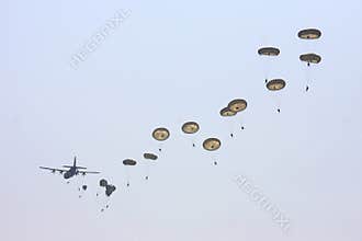Hercules plane drops many parachute troopers