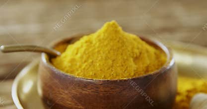Turmeric powder in bowl on a plate 4k
