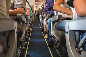 Cabin of airplane with passengers on seats