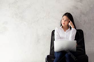 Beautiful young asian woman working and thinking with problem to stress and unhappy
