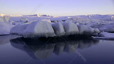 Floating ice on Jokulsarlon glacier lake in ultraviolet at sunrise