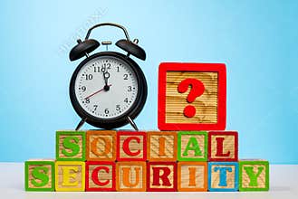 Alarm clock on wooden blocks for Social Security