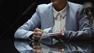 Businesswoman taking envelope with money, corruption and tax evasion, close up