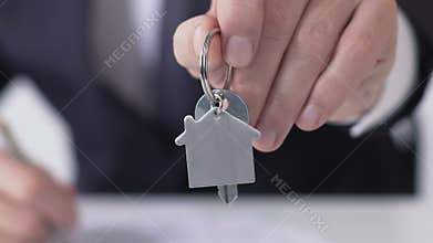 Close-up of company manager holding apartment keys, building purchase deal