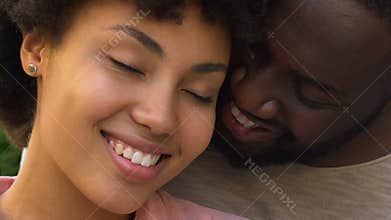 Happy afro american couple embracing and smiling, closeness, spiritual affinity