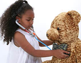 Adorable Little Playing Doctor To A Teddy Bear Over White