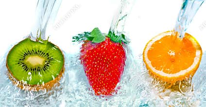 Fresh fruit jumping into water with a splash