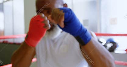 Senior man boxing in the fitness studio 4k