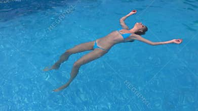 Woman floating limp in water