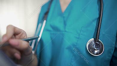 Female nurse with stethoscope writing symptoms, diagnostics and prescriptions