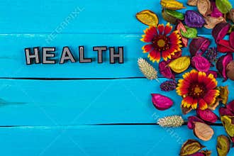 Health word on blue wood with flower