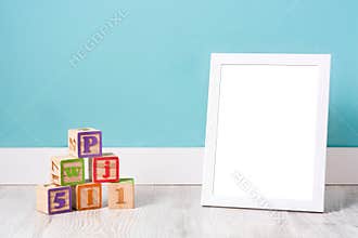 Frame mockup and wooden cubes for kids on white wooden floor