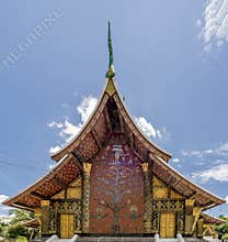 Detail of the beautiful mosaic `The Tree of Life` in the famous Wat Xieng Thong temple of Luang Prabang, Laos