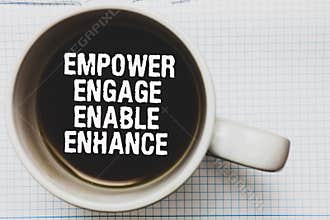 Writing note showing Empower Engage Enable Enhance. Business photo showcasing Empowerment Leadership Motivation Engagement Coffee