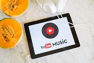 Youtube music logo shown on tablet screen with fresh fruit