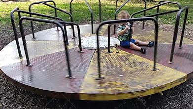 Little boy on a moving merry-go-round