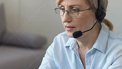 Mature woman psychologist holding online consultation, helping people from home