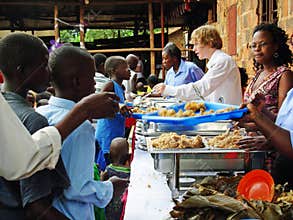 Team aid relief volunteers workers feeding hungry children Africa